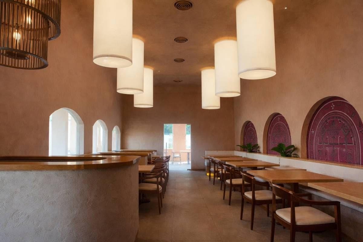 QumQum dining room with arched windows and pendant lights