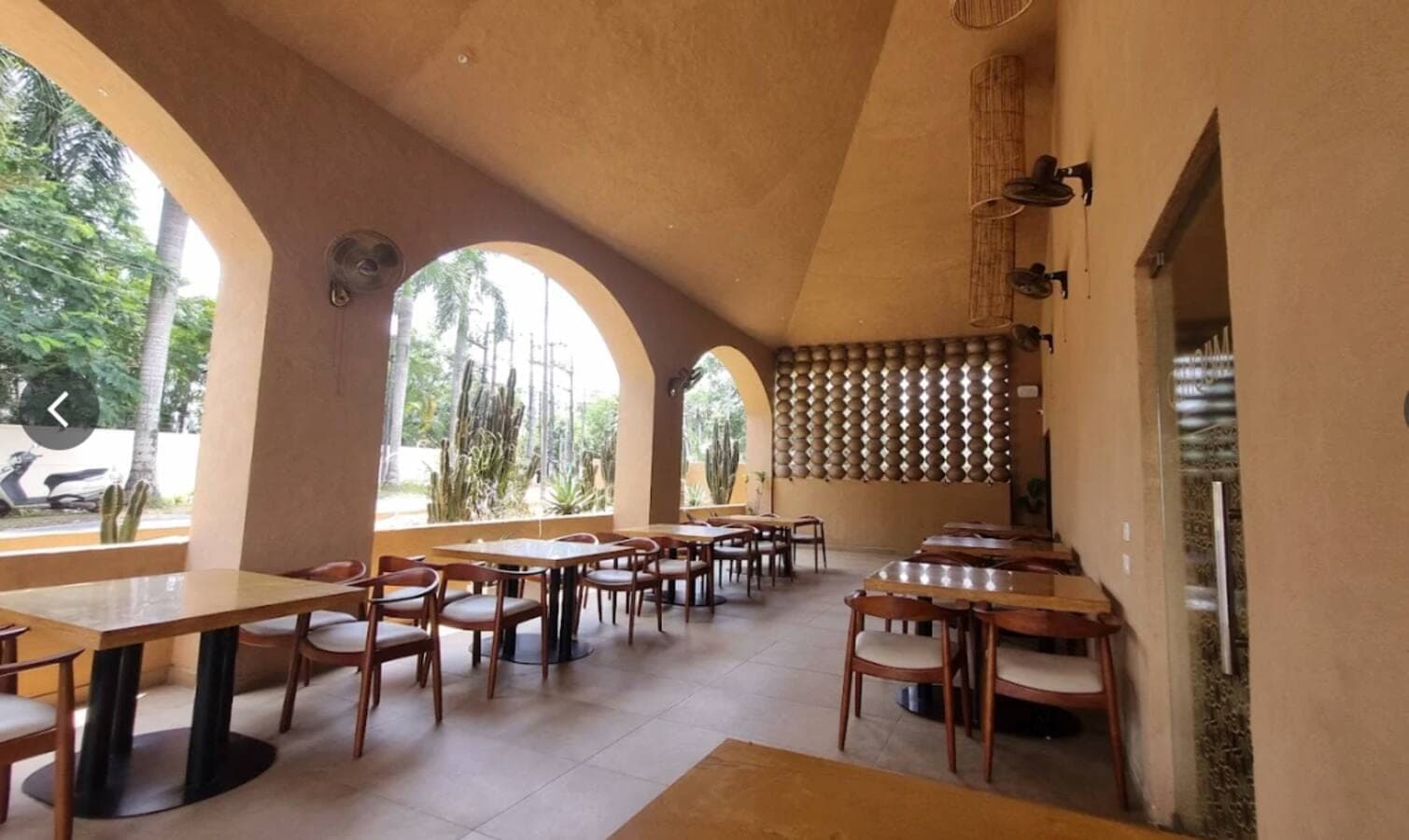 Outdoor seating with arched openings at QumQum