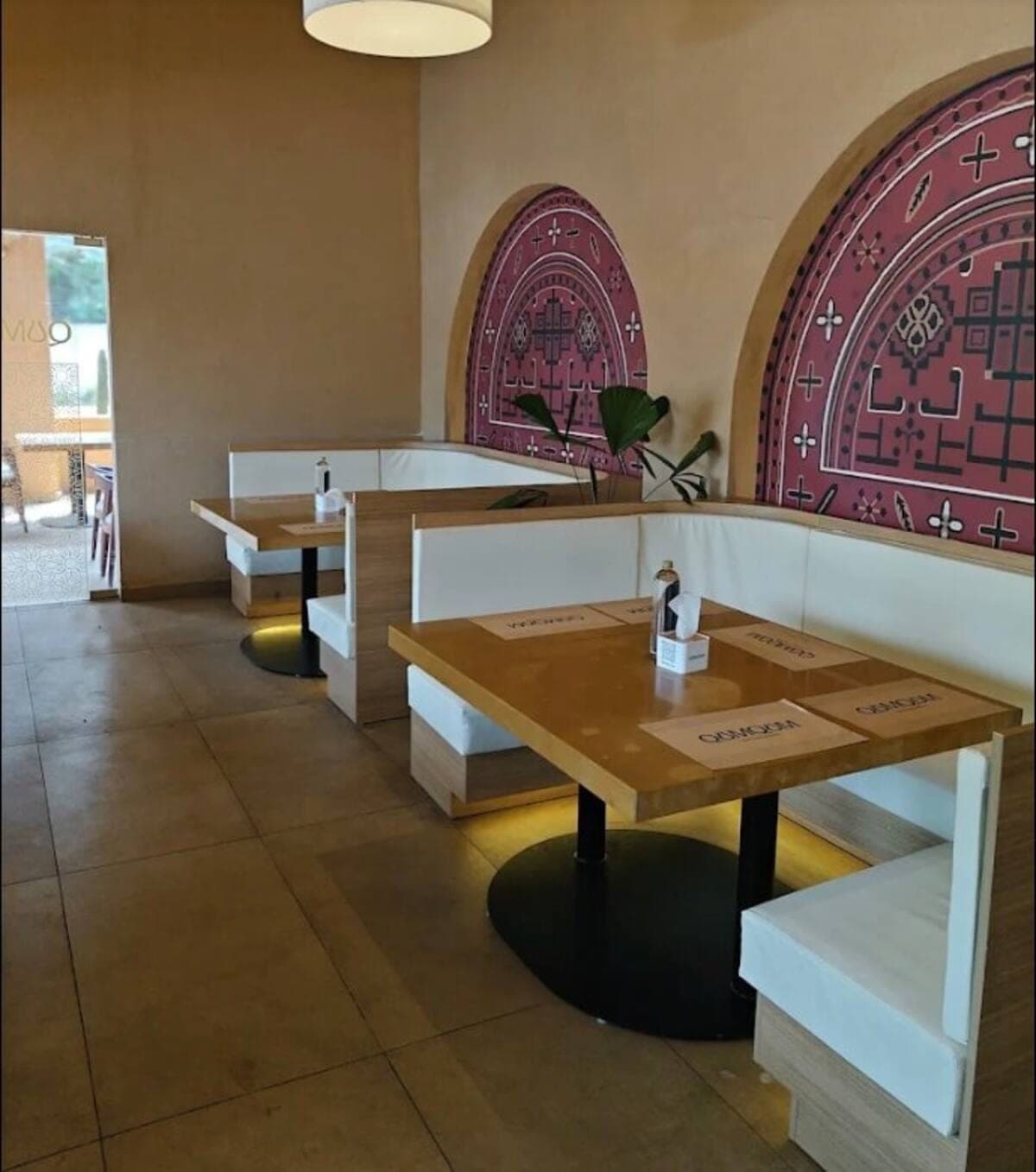 Arabian wall art and booth seating inside QumQum