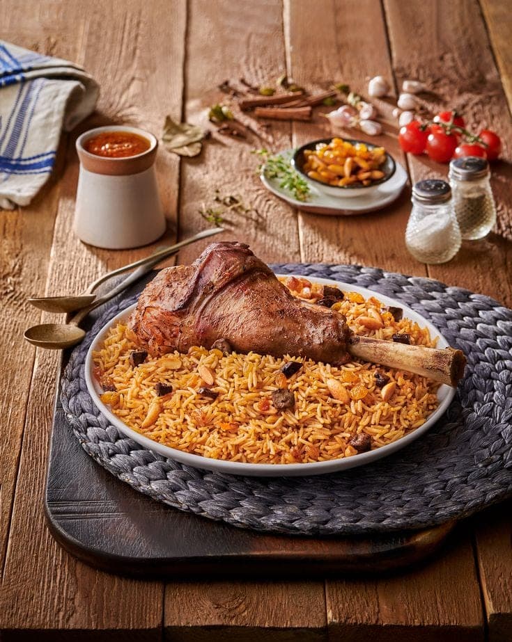 Lamb shank mandi with spiced rice and tomato daqqus